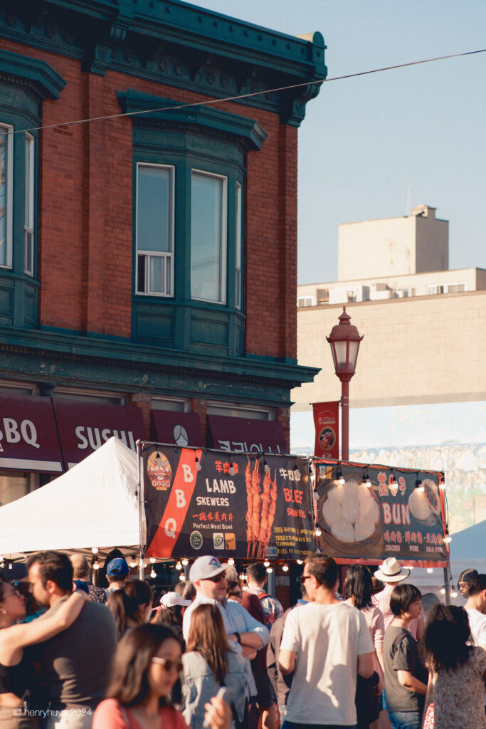 Amidst the festive crowd, a Korean restaurant provides a tantalizing backdrop.