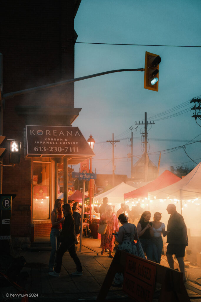 The area is enveloped in smoke as the grill works its magic, adding to the atmosphere of the bustling scene.